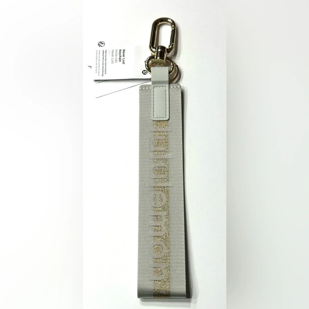 Lululemon Never Lost Keychain Wordmark Vapor Gold, NEW